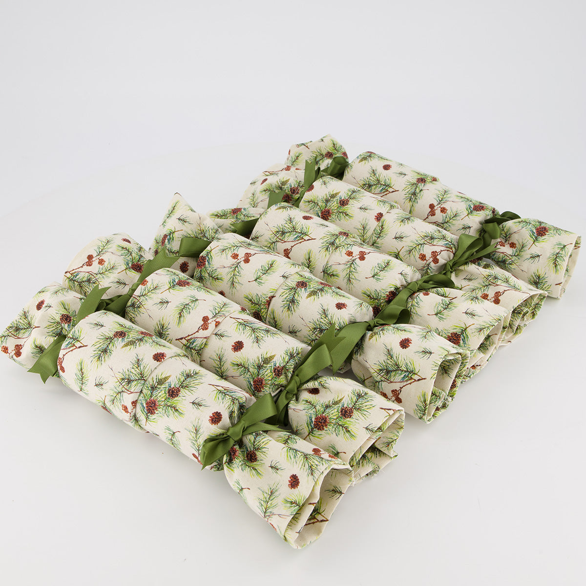 Giuthas na Nollaige reusable Christmas crackers — 6 crackers unboxed in a row — pine branches & pinecones in natural tones — handmade in Afghanistan